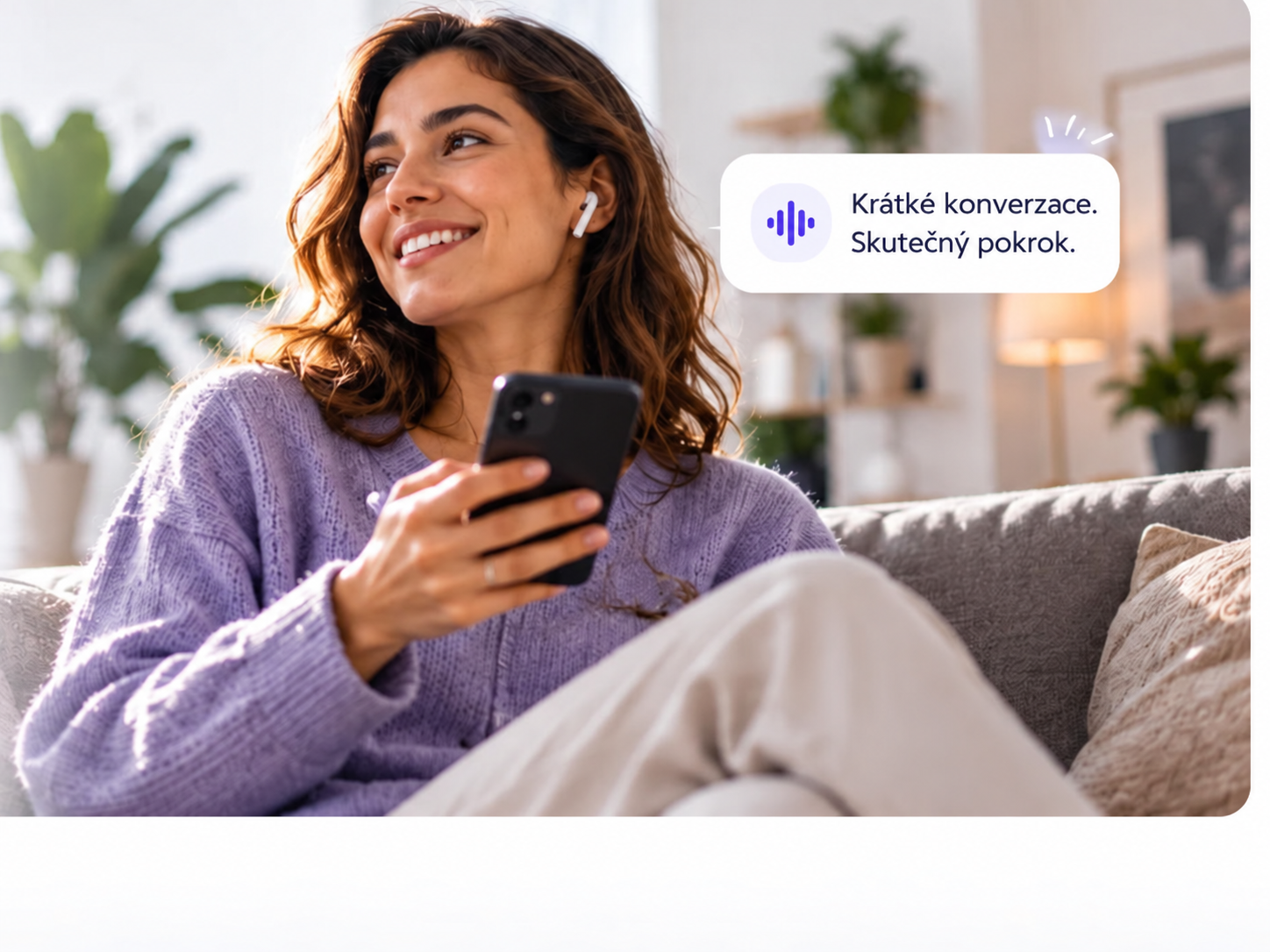 Language learner smiling while using her phone for a short speaking practice session